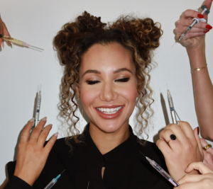 woman smiling surrounded by needles